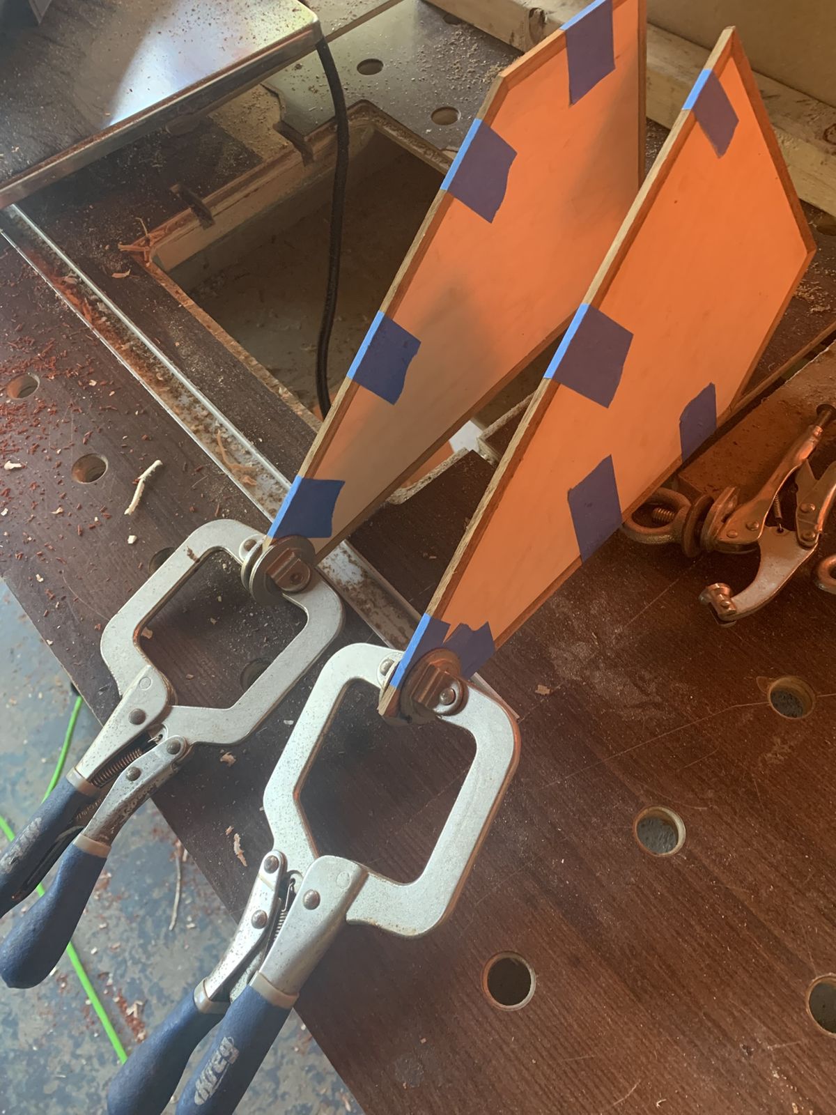 Plywood stand panels clamped in the workshop